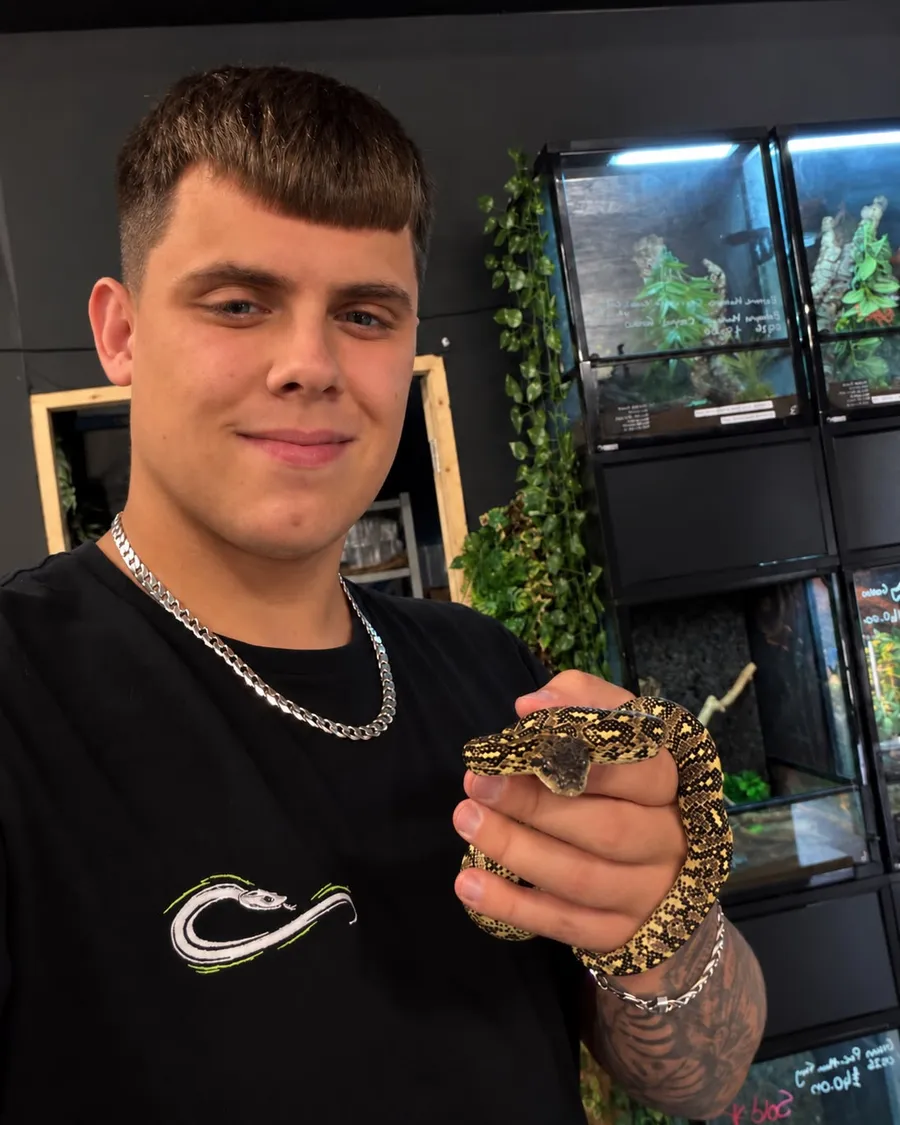 The founder of Wright's Reptiles holding a snake in the shop